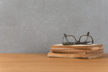 stack of old books with glassesの写真素材