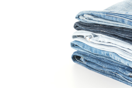 Stack of jeans on white backgroundの写真素材