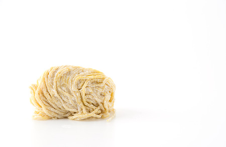 yellow noodles on white backgroundの写真素材