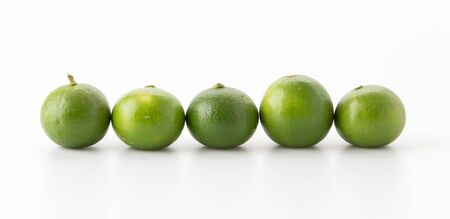 green lemon isolated on white backgroundの写真素材