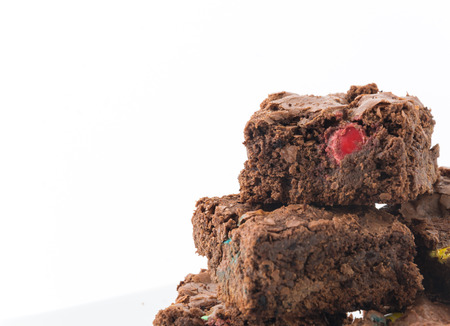 chocolate brownie with chocolate chips on white backgroundの写真素材