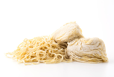 yellow noodles on white backgroundの写真素材