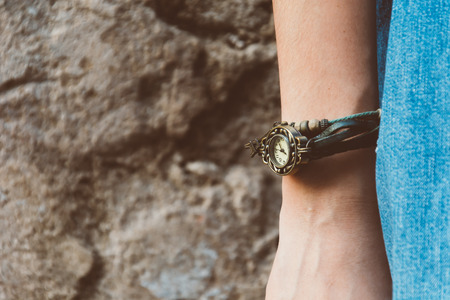 Watch bracelet on hand and jean with film texture in vintagestyleの写真素材