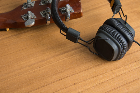 headphone and guitar on woodの写真素材