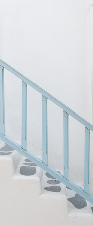 Sloping concrete stair steps and wood handrailの写真素材