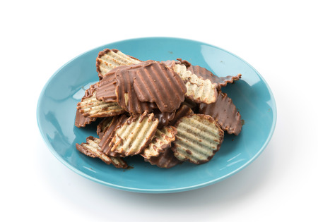 potato chip with chocolate on whiteの写真素材
