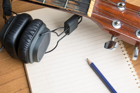 headphone guitar notebook and pencil
