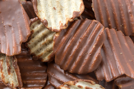 potato chip with chocolate on whiteの写真素材