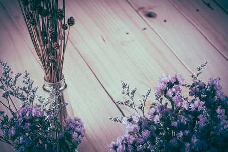 statice flower bouquet  on wood background - soft focus with vintage film filterの写真素材