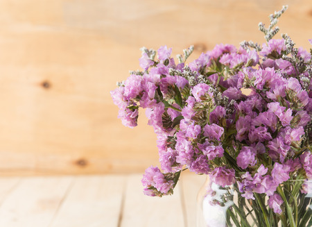 statice flower bouquet  on wood backgroundの写真素材