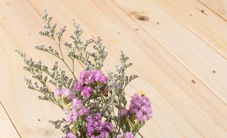 statice flower bouquet  on wood backgroundの写真素材