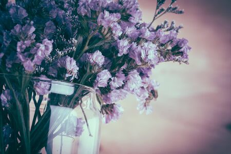 statice flower bouquet  on wood background - soft focus with vintage film filterの写真素材