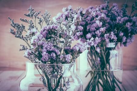 statice flower bouquet  on wood background - soft focus with vintage film filterの写真素材