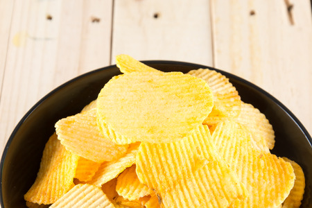 potato chips on wood backgroundの写真素材