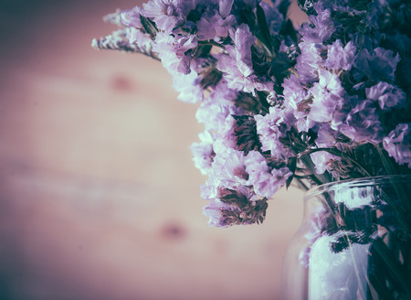 statice flower bouquet  on wood background - soft focus with vintage film filterの写真素材