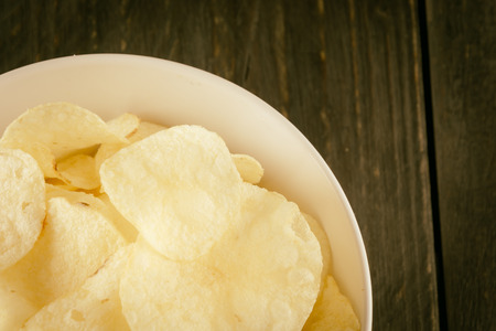 potato chips on wood - soft focus with vintage film filterの写真素材
