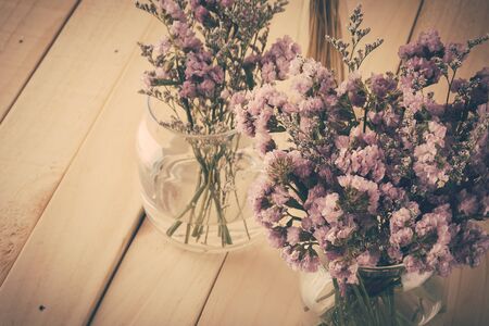 statice flower bouquet  on wood backgroundの写真素材
