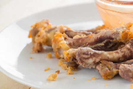 chicken bone on white plateの写真素材