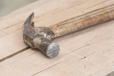a hammer is on woodの写真素材