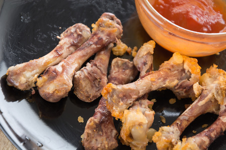 chicken bone on black plate