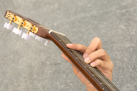 hand playing on acoustic guitar - soft focus with vintage filterの写真素材