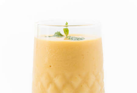 fresh mango smoothie on white backgroundの写真素材