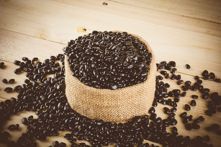 red  beans on wood background - soft focus with vintage film filterの写真素材