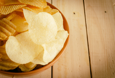 potato chips on wood - soft focus with vintage film filterの写真素材