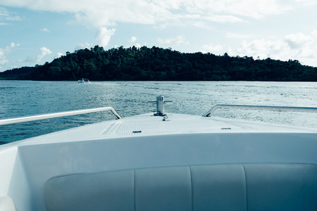 Bow of speed boat heading in the sea - soft focus with film filterの写真素材