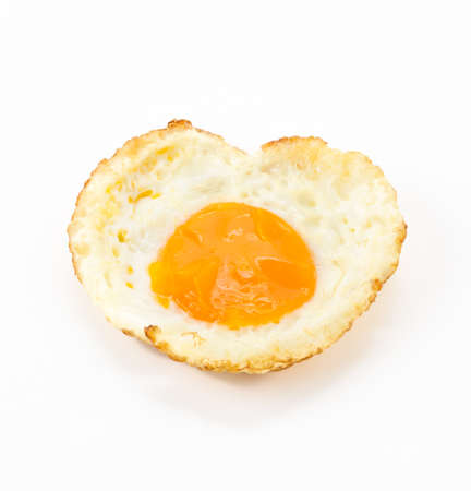 fried egg on white backgroundの写真素材