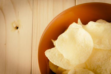 potato chips on wood - soft focus with vintage film filterの写真素材