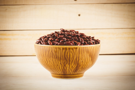 red  beans on wood background - soft focus with vintage film filter