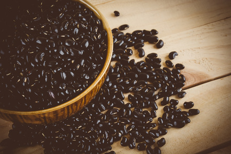 red  beans on wood background - soft focus with vintage film filterの写真素材