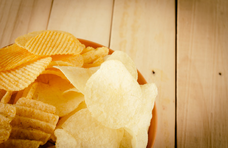 potato chips on wood - soft focus with vintage film filterの写真素材