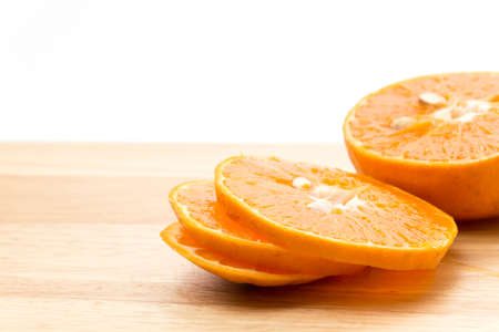 orange slice on wood boardの写真素材