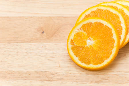 orange slice on wood boardの写真素材