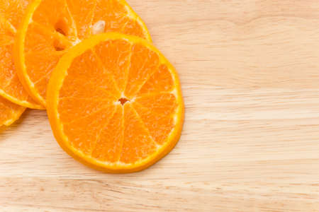 orange slice on wood boardの写真素材
