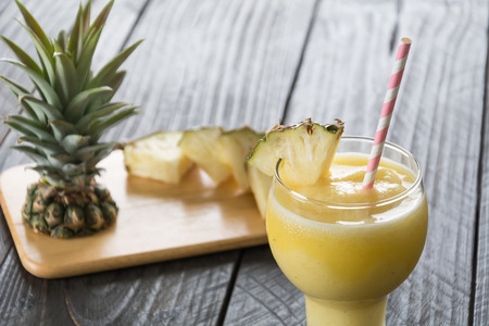 pineapple smoothie on wood backgroundの写真素材