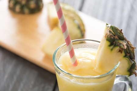 pineapple smoothie on wood backgroundの写真素材