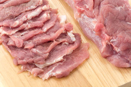 slice pork on wood board