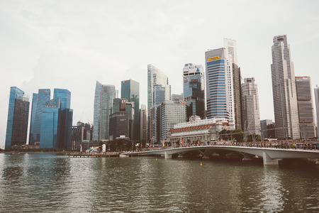 SINGAPORE, SINGAPORE - JULY 17 2015: View of downtown Singapore city. Singapore is one of the world's major commercial hubs.- with film filter effectのeditorial素材