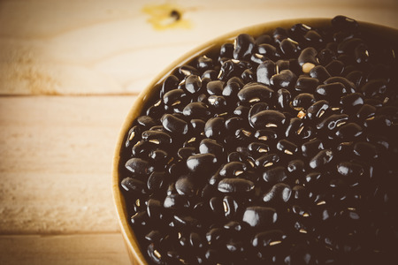 red  beans on wood background - soft focus with vintage film filterの写真素材