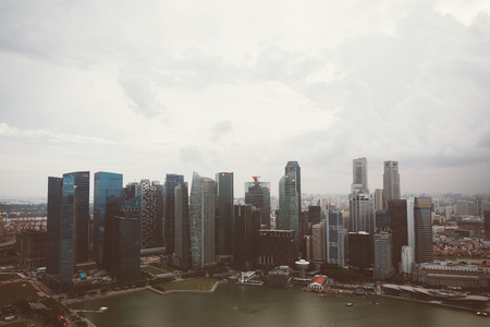 SINGAPORE, SINGAPORE - JULY 16 2015: View of downtown Singapore city. Singapore is one of the world's major commercial hubs.- with film filter effectのeditorial素材