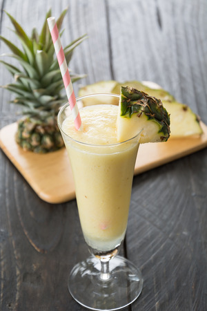 pineapple smoothie on wood backgroundの写真素材