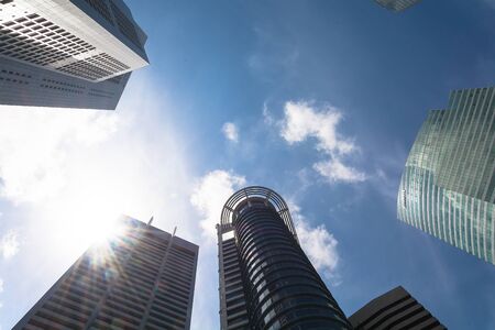 Skyscrapers with clouds and flare