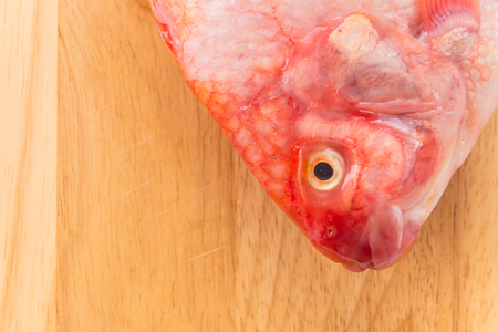 Red Tilapia on wood boardの写真素材