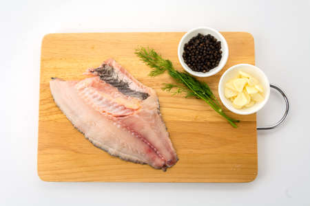 tilapia raw on wood boardの写真素材
