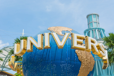 SINGAPORE - JULY 20: Tourists and theme park visitors taking pictures of the large rotating globe fountain in front of Universal Studios.のeditorial素材