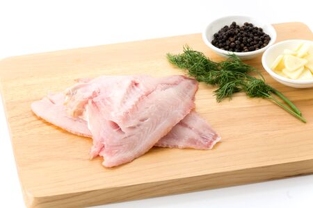 tilapia raw on wood board