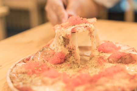 smoked salmon pizza on wood tableの写真素材
